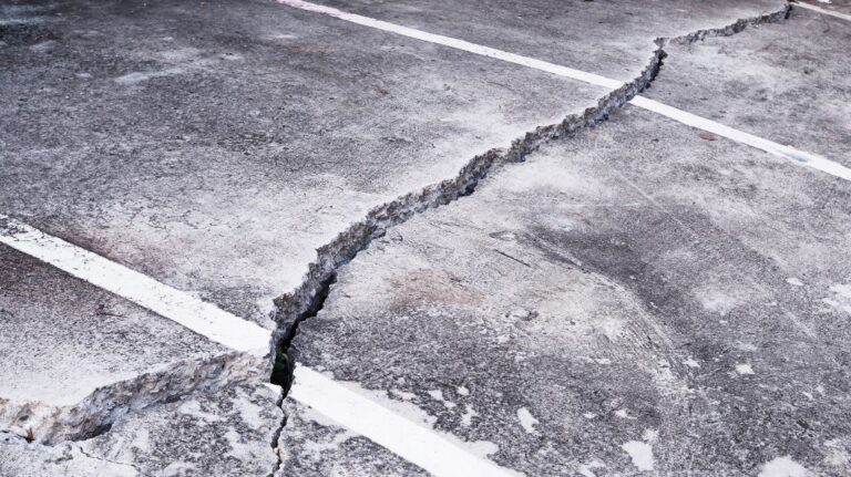 damaged and cracked concrete parking lot