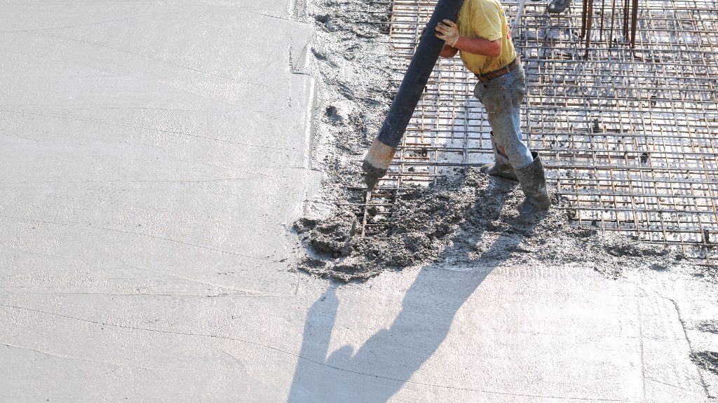 Concrete pouring during commercial concreting floors of buildings in construction