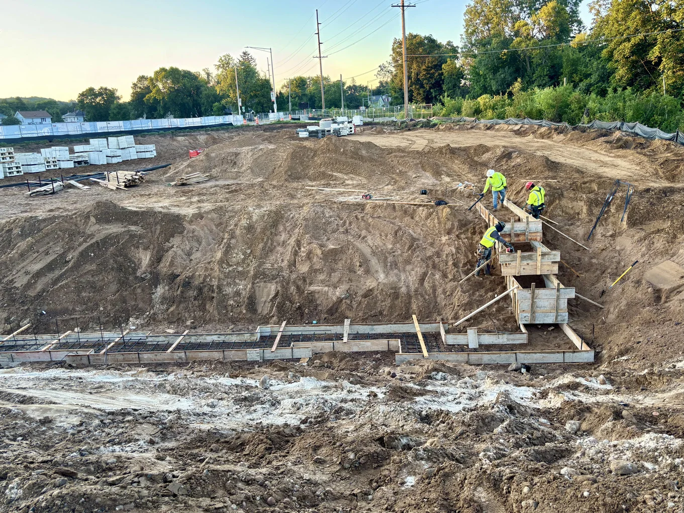 Construction workers collaborating on a busy construction site, using tools and equipment to build structures