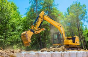 Yellow Back Hoe Building Retaining Wall